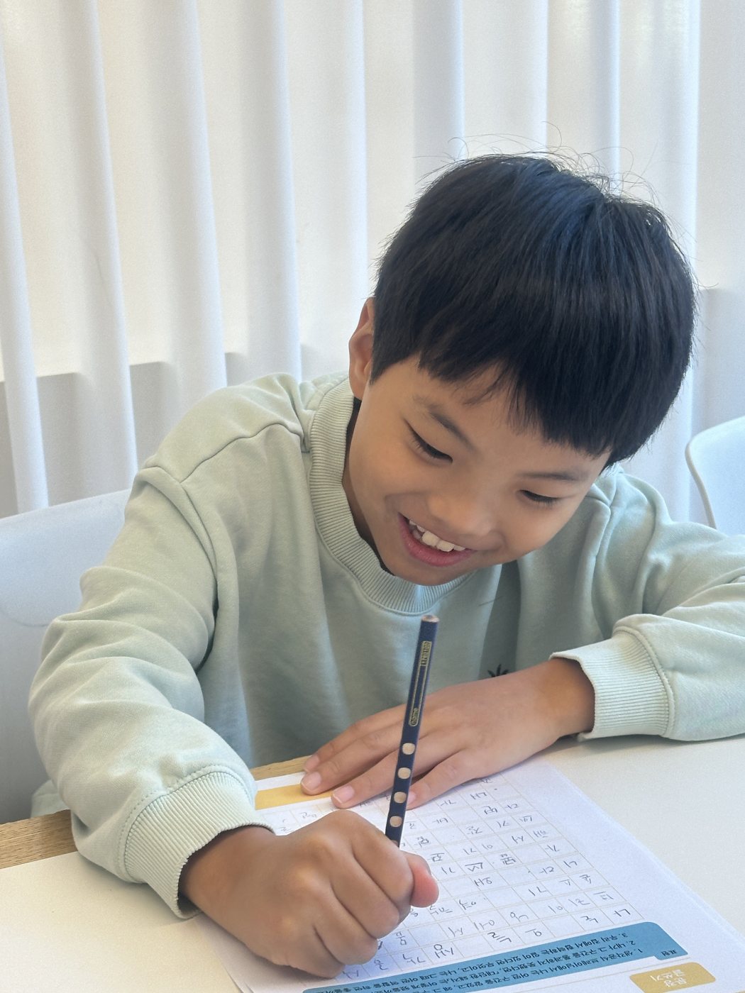 글쓰기를 하며 웃는 아이